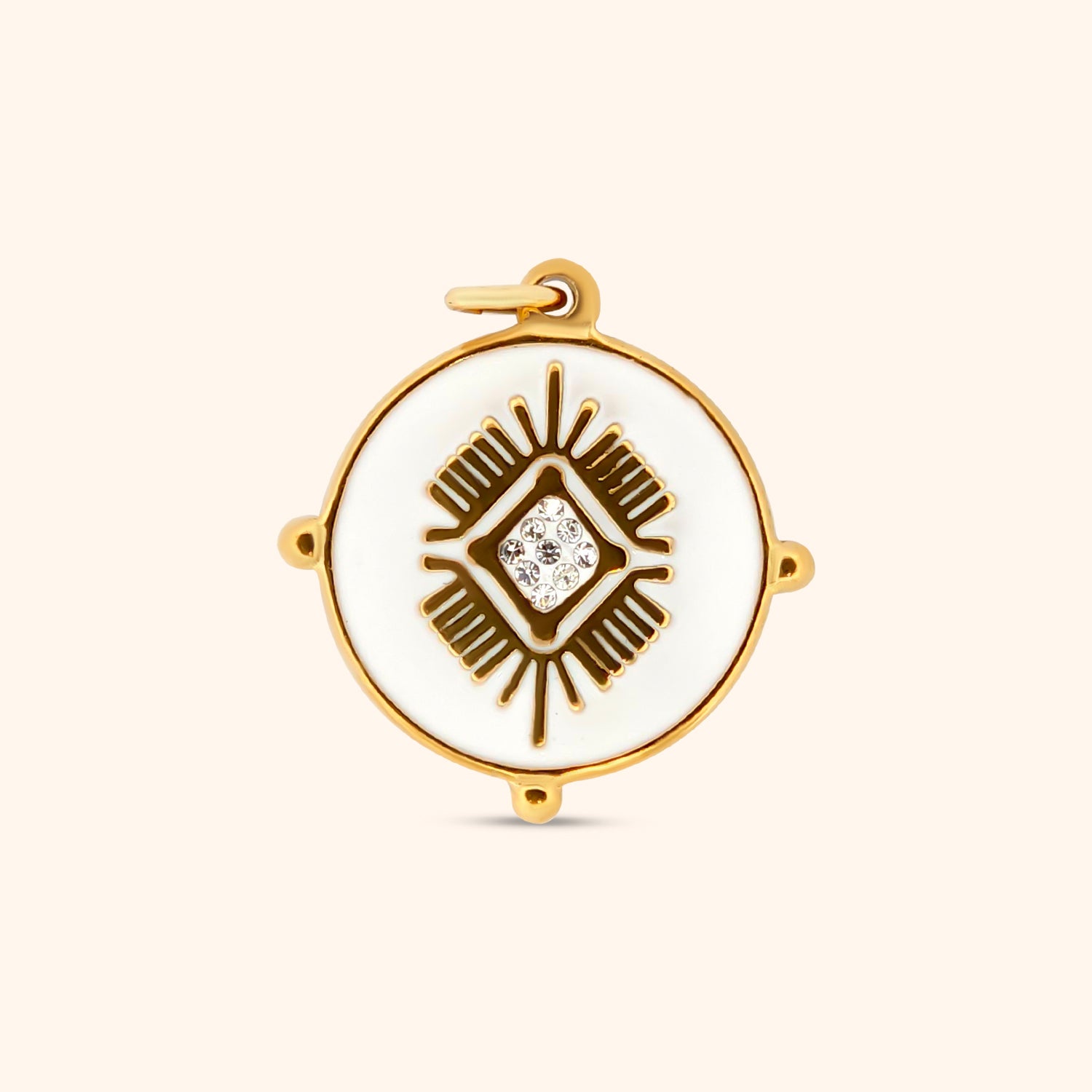 Close-up of the Andes Charm, a circular charm featuring white enamel and intricate gold detailing, inspired by Machu Picchu.